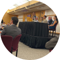 Person speaking at an indoor event.